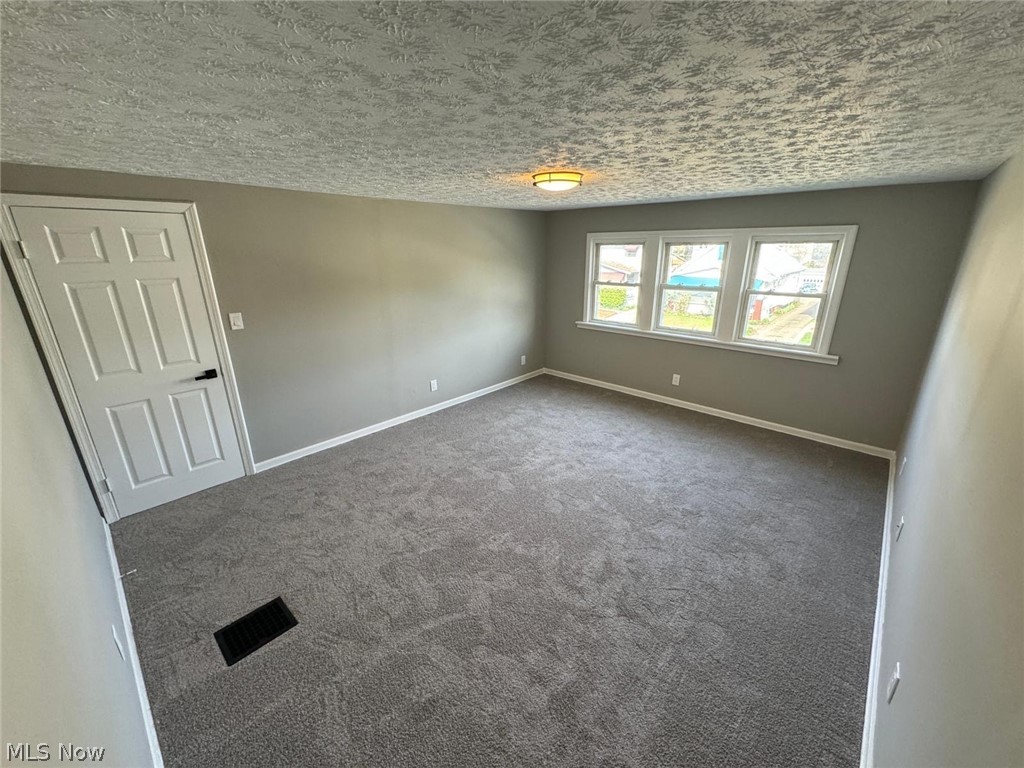 3356 Berea Road Cleveland, OH 44111 - Photo 22 of 35 Carpeted spare room with a textured ceiling