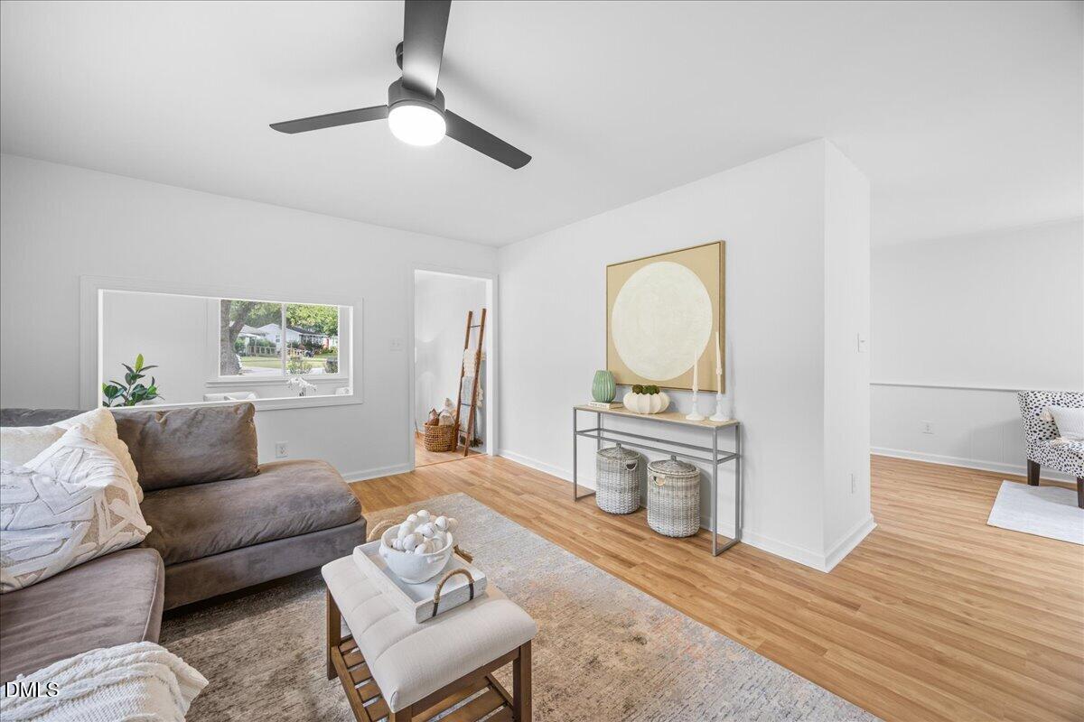 3437 Apache Drive Raleigh, NC 27609 - Photo 12 of 40 LVP flooring, white walls, and a ceiling fan with integrated lighting