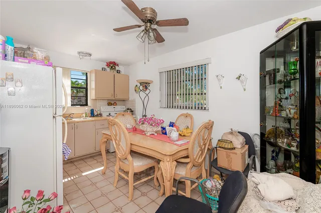 a bedroom with a bed dresser and a chandelier