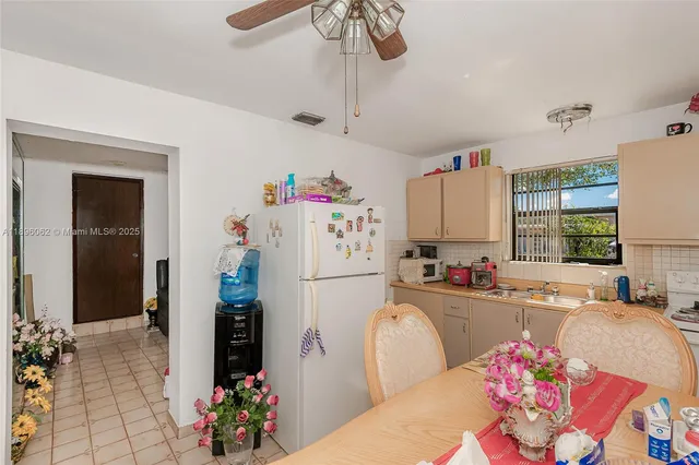 a view of a patio with a table chairs and a floor to ceiling window