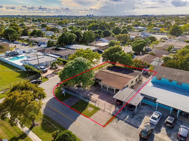 a living room with furniture and a view of kitchen