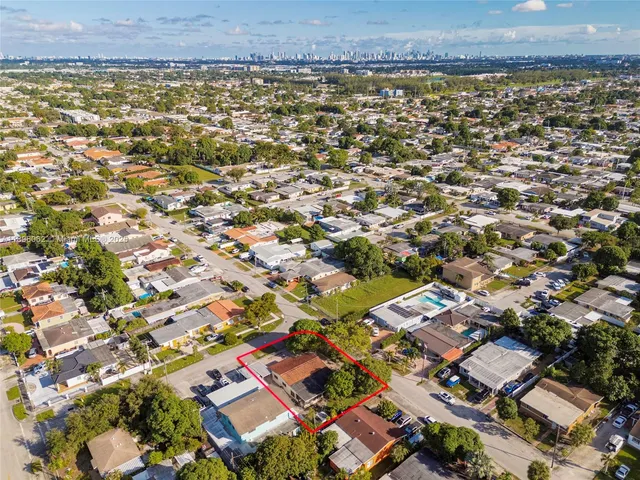 a living room with furniture and a dining table with wooden floor