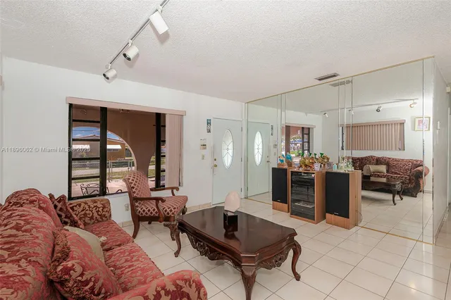a living room with furniture and a floor to ceiling window