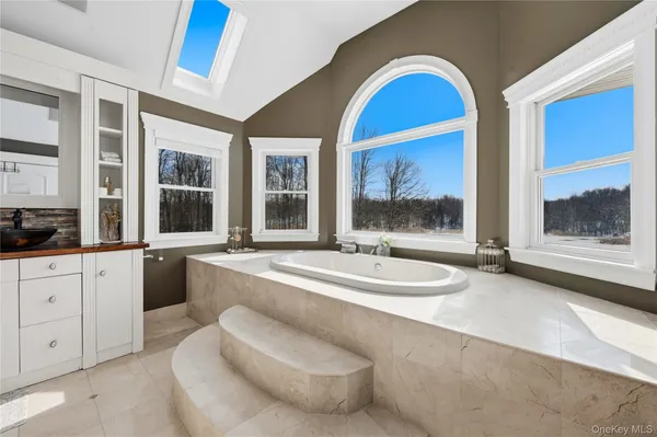 a bathroom with a glass shower door and a sink