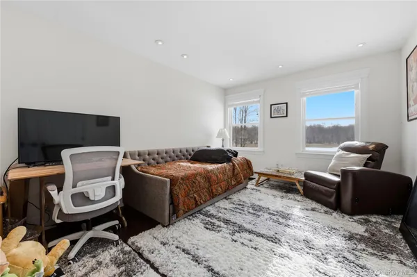 a bedroom with a bed and glass window