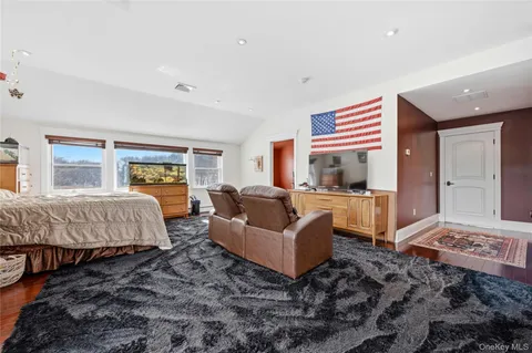 a bedroom with a bed and glass window