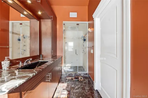 a bathroom with double vanity and a bathtub