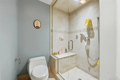 a bathroom with a toilet sink shower and mirror