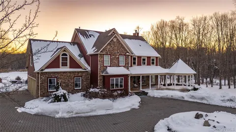 a front view of a house with yard patio and fire pit