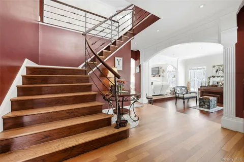 a view of entryway and hall with wooden floor