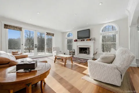 a living room with furniture fireplace and a flat screen tv
