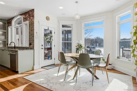 a dining room with furniture and window