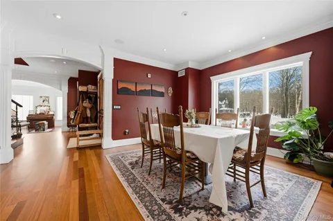 a dining room with furniture and wooden floor