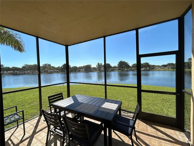 a view of an outdoor dining space with a table and chairs