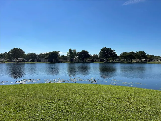 a view of a lake with houses in the background