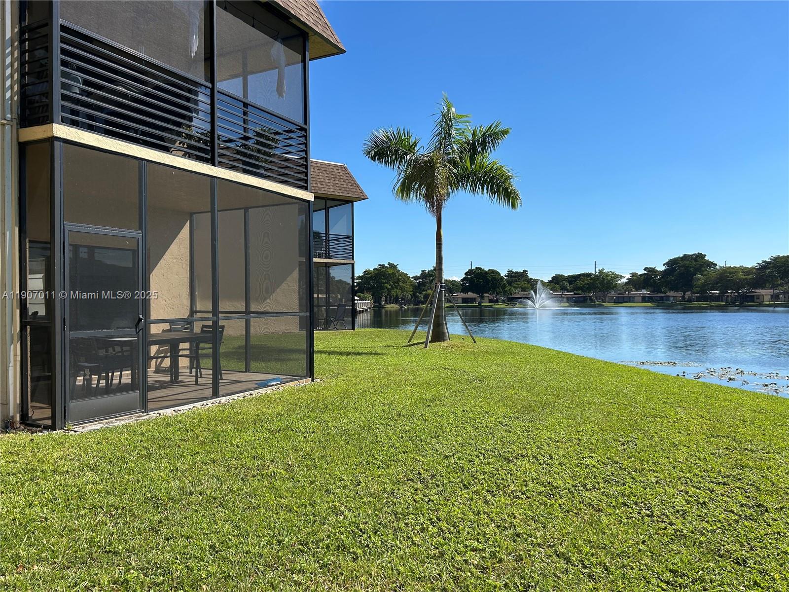 200 Berkley Road, Unit 113 Hollywood, FL 33024 - Photo 15 of 38 a view of a lake with a garden
