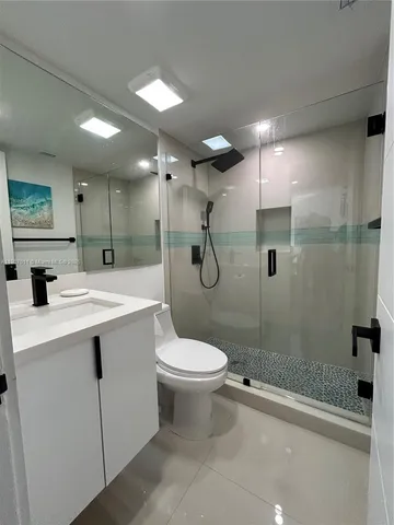 a bathroom with a sink toilet and shower
