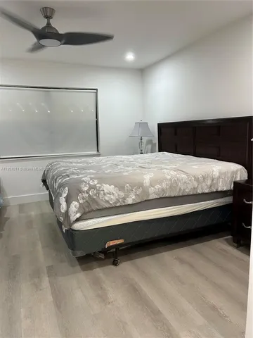 a bedroom with a bed and a view of kitchen