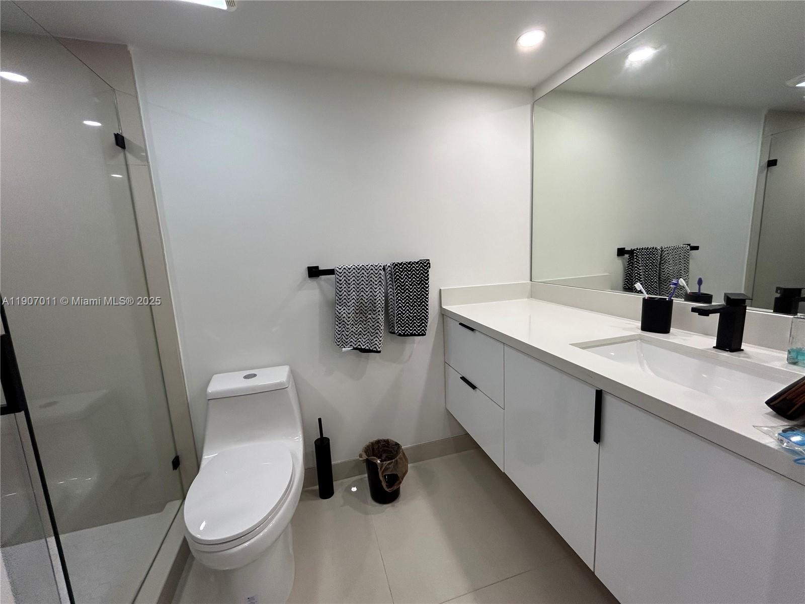 200 Berkley Road, Unit 113 Hollywood, FL 33024 - Photo 22 of 38 a bathroom with a toilet sink and mirror