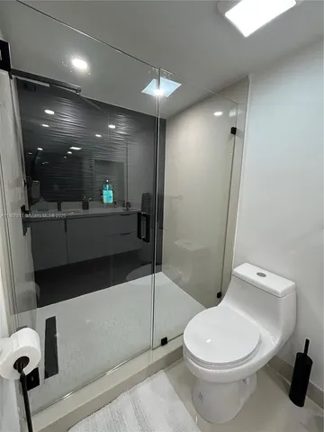 a bathroom with a toilet a sink and a shower