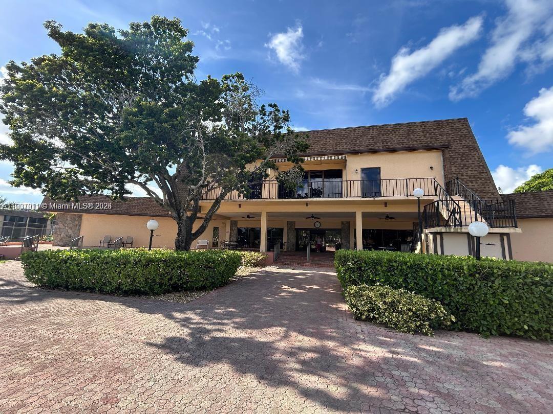 200 Berkley Road, Unit 113 Hollywood, FL 33024 - Photo 27 of 38 a front view of a house with a garden