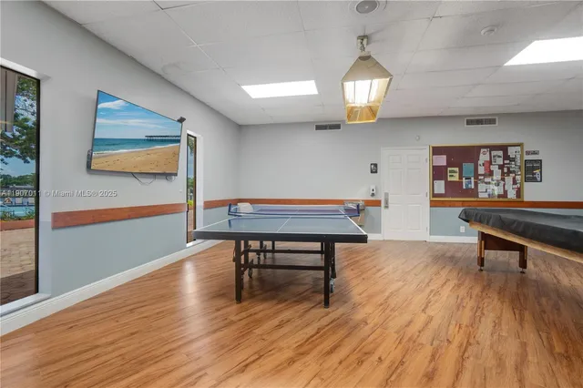 a living room with furniture a table and wooden floor