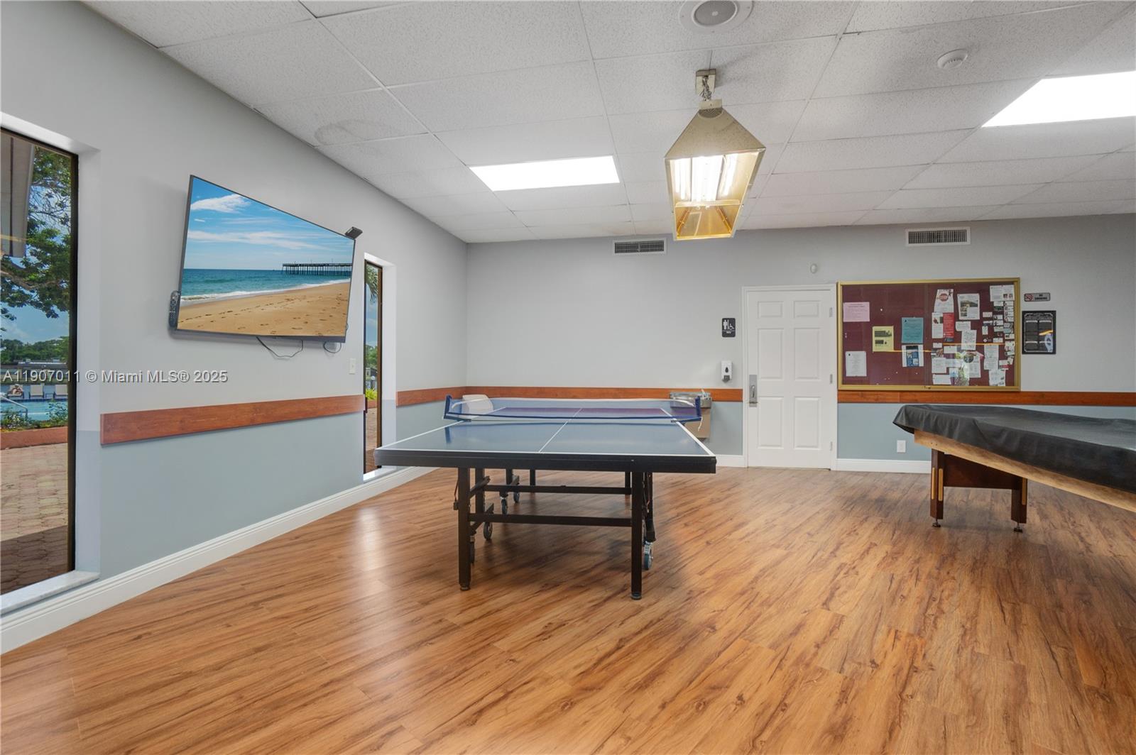 200 Berkley Road, Unit 113 Hollywood, FL 33024 - Photo 29 of 38 a living room with furniture a table and wooden floor