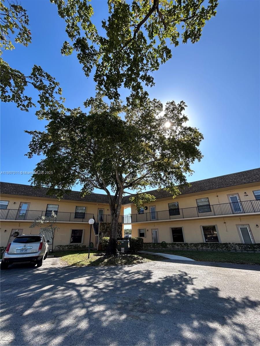 200 Berkley Road, Unit 113 Hollywood, FL 33024 - Photo 3 of 38 a view of a car park in front of a building