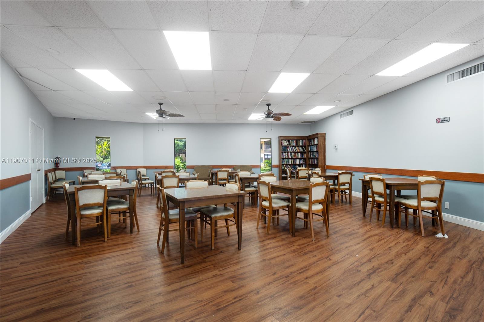 200 Berkley Road, Unit 113 Hollywood, FL 33024 - Photo 31 of 38 a view of a dining area with furniture wooden floor and chandelier