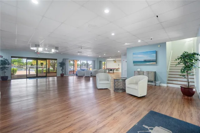 a dinning room and dining room with furniture wooden floor and chandelier