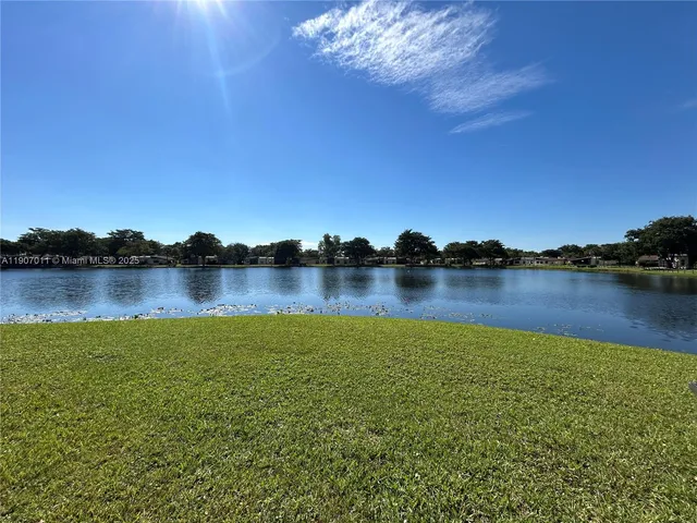a view of a lake with houses in the background