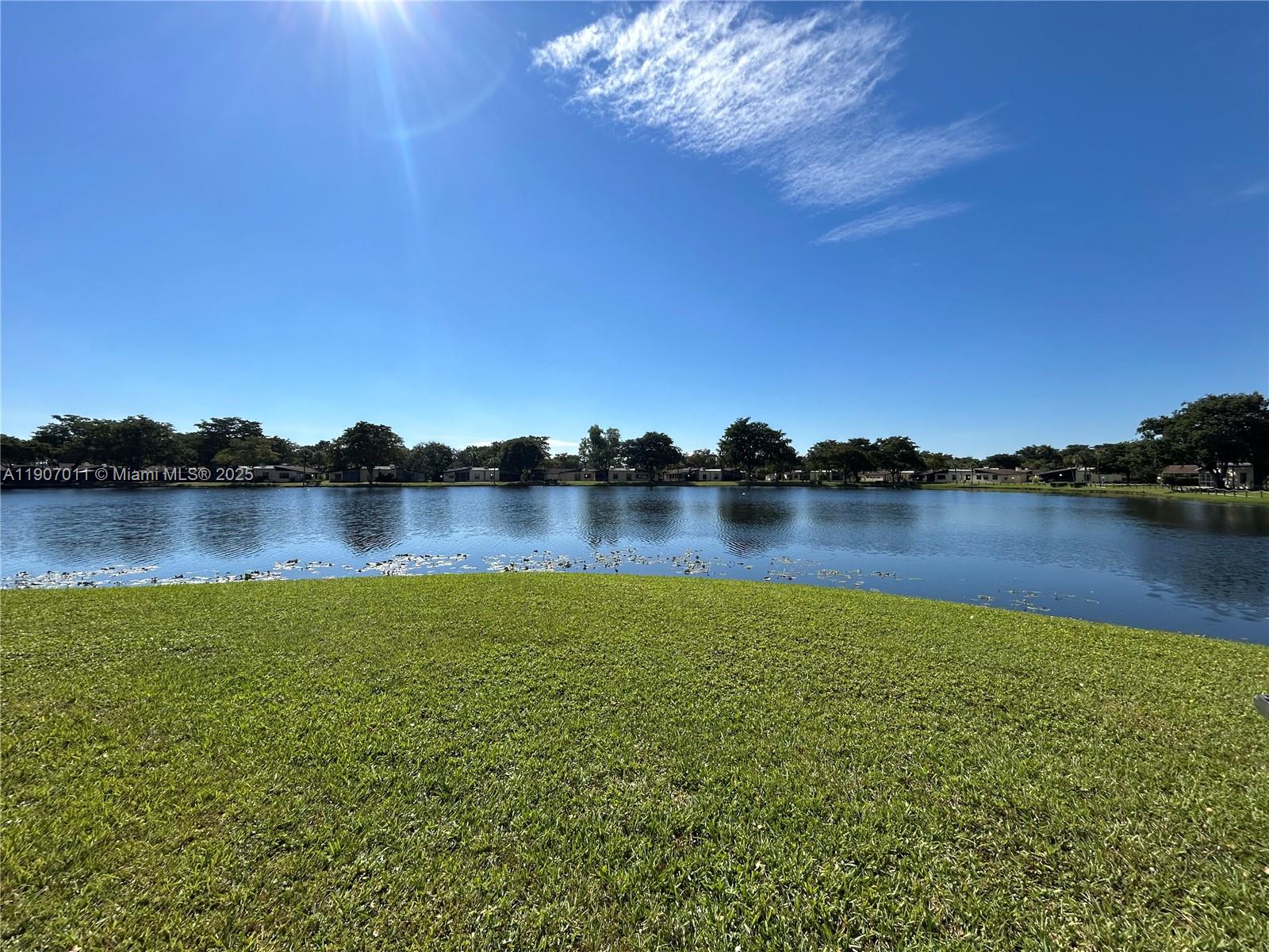 200 Berkley Road, Unit 113 Hollywood, FL 33024 - Photo 37 of 38 a view of a lake with houses in the background