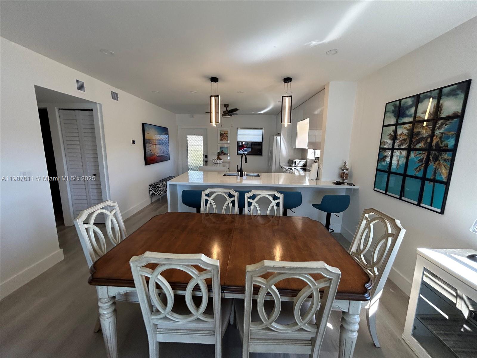 200 Berkley Road, Unit 113 Hollywood, FL 33024 - Photo 8 of 38 a view of a dining room with furniture large window and wooden floor