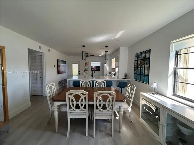 a view of a dining room with furniture and windows