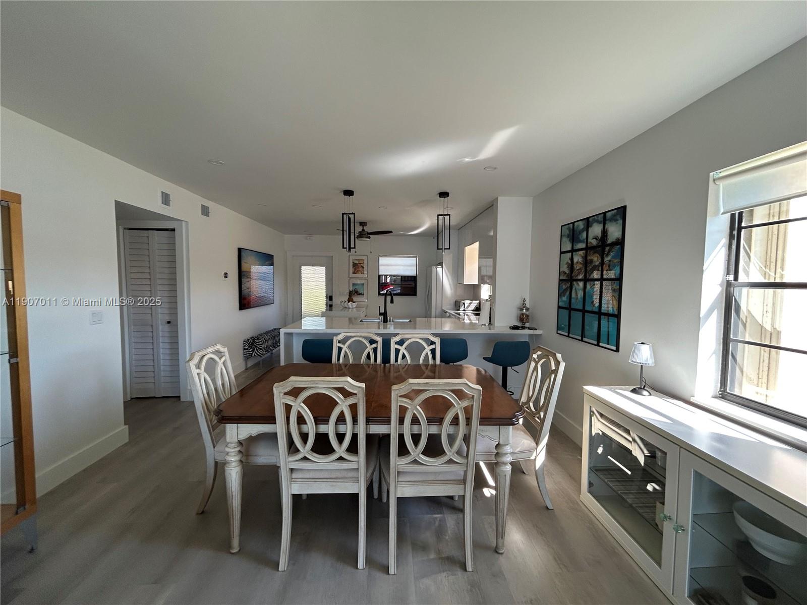 200 Berkley Road, Unit 113 Hollywood, FL 33024 - Photo 9 of 38 a view of a dining room with furniture and windows