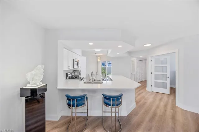 a kitchen with stainless steel appliances kitchen island granite countertop a sink and cabinets
