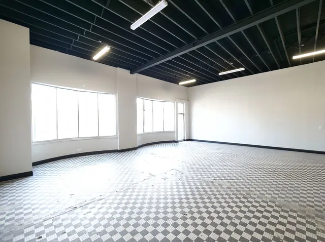 a kitchen with a table chairs and a view of living room