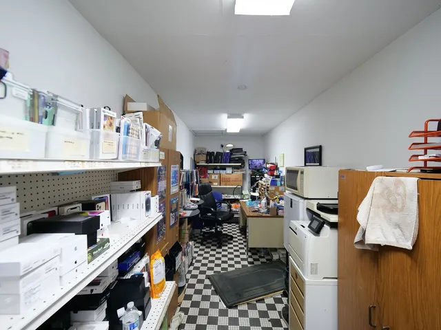 a kitchen with lots of counter top space and living room view