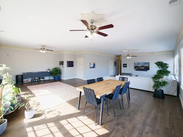 a view of a livingroom with furniture a ceiling fan and window