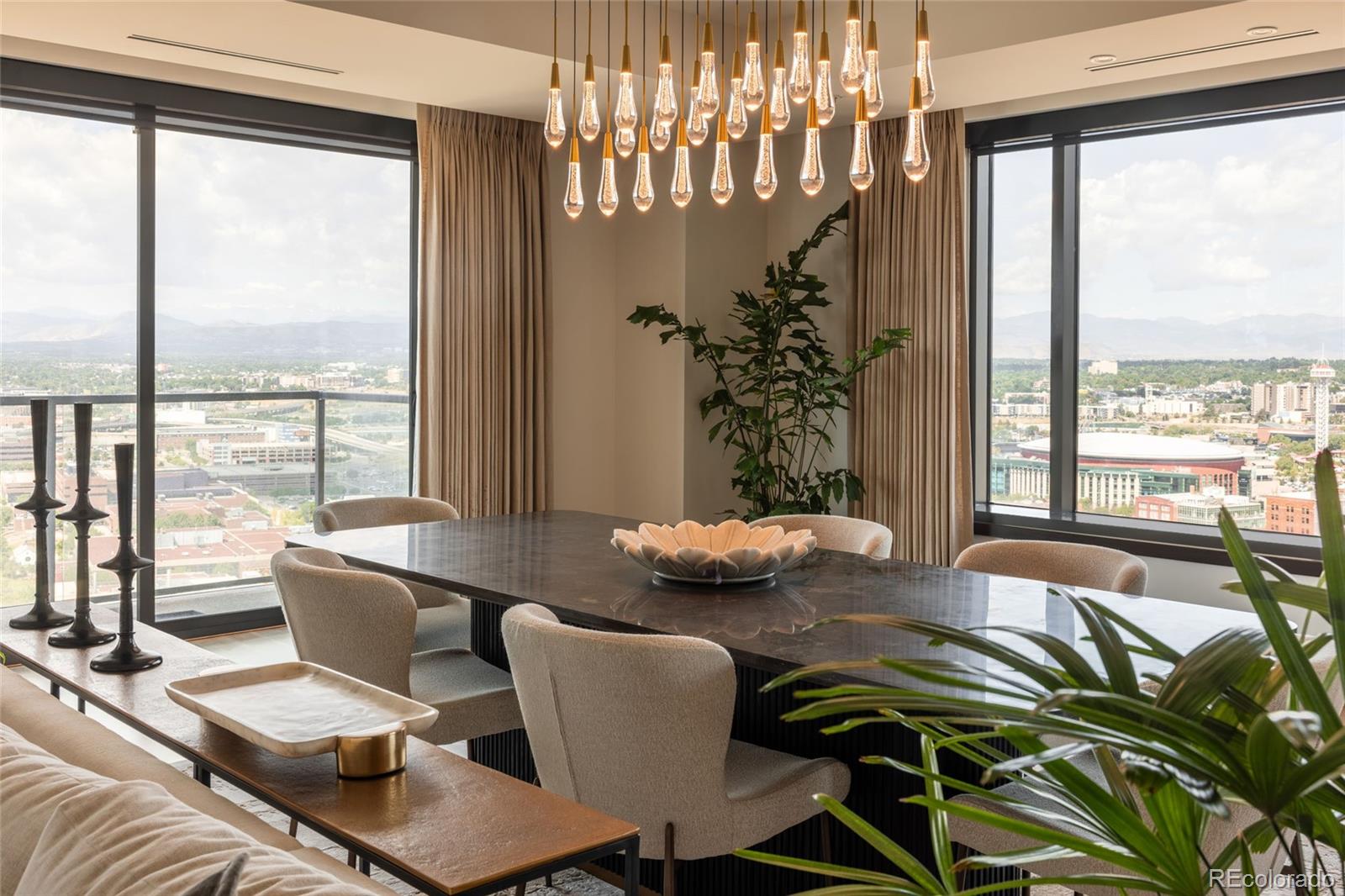 a living room with furniture and floor to ceiling windows