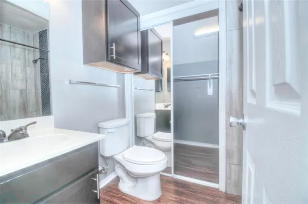 a bathroom with a toilet and a shower
