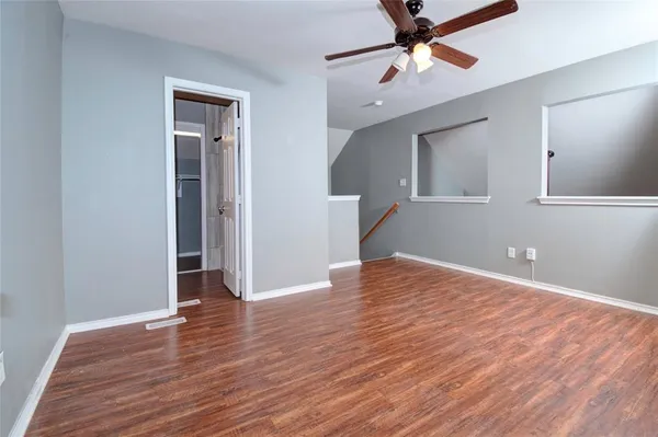 a view of empty room with wooden floor