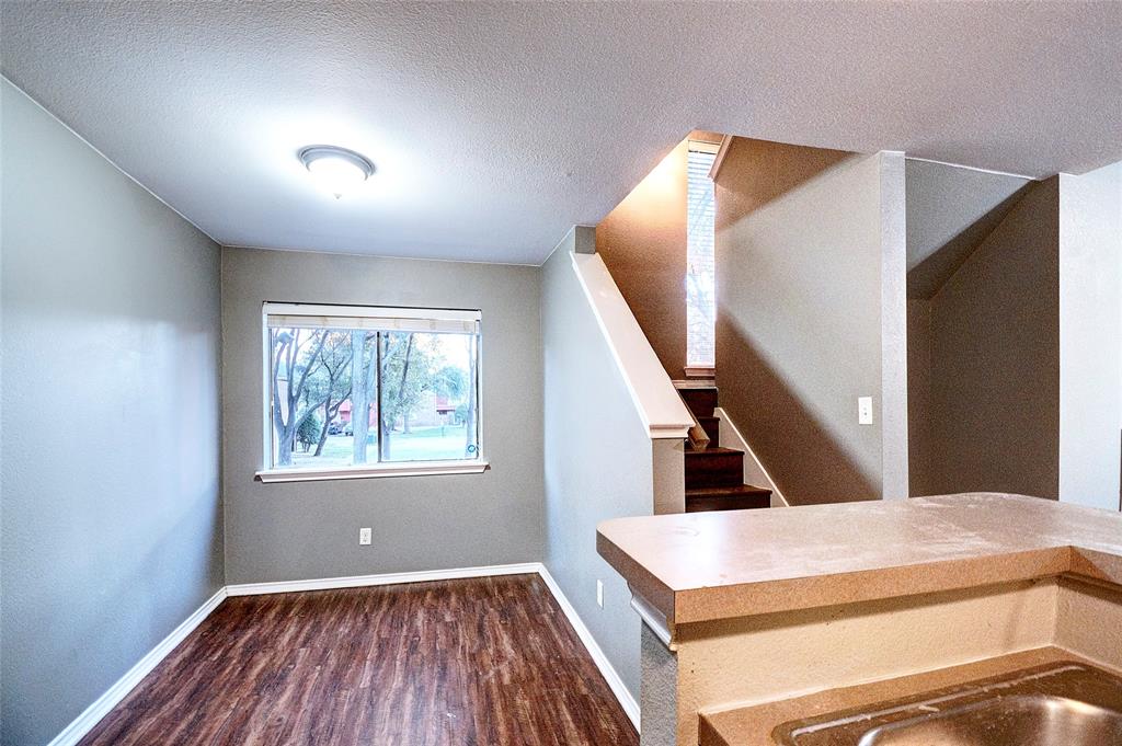 9831 Walnut Street, Unit 209 Dallas, TX 75243 - Photo 16 of 26 a view of an empty room and wooden floor