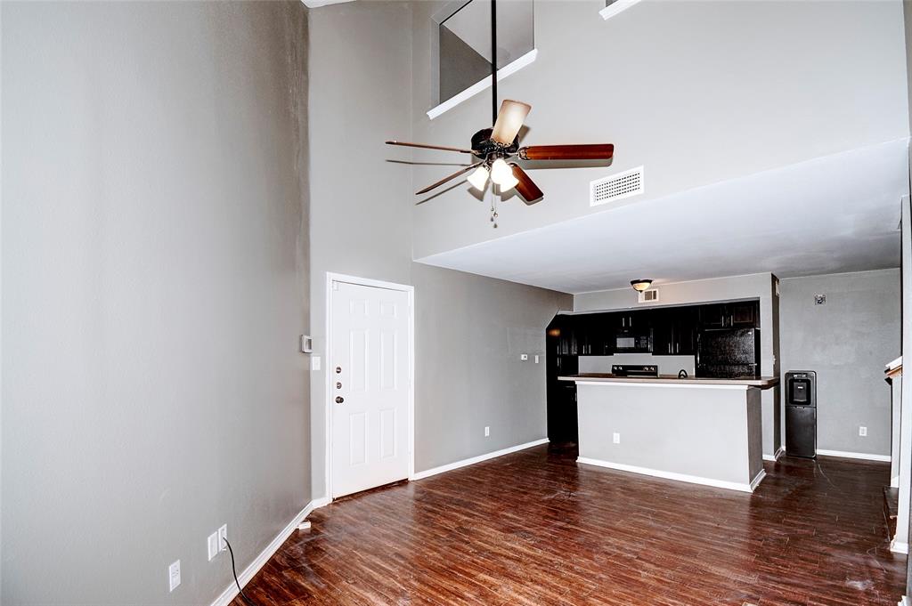 9831 Walnut Street, Unit 209 Dallas, TX 75243 - Photo 18 of 26 a view of a kitchen with a wooden floor and a ceiling fan