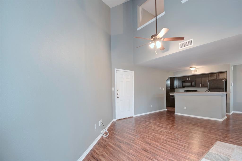 9831 Walnut Street, Unit 209 Dallas, TX 75243 - Photo 2 of 26 a view of a kitchen with a sink and dishwasher with wooden floor
