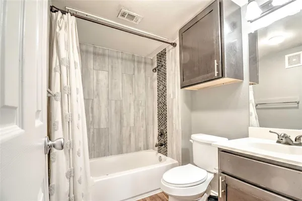 a white toilet sitting next to a bathroom sink
