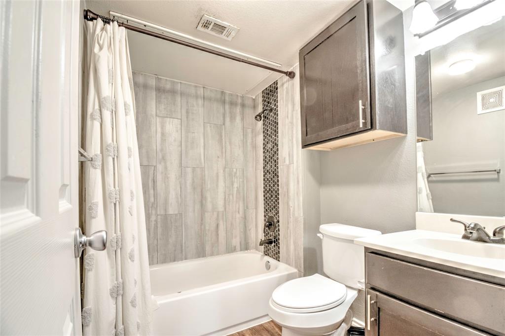 9831 Walnut Street, Unit 209 Dallas, TX 75243 - Photo 7 of 26 a white toilet sitting next to a bathroom sink