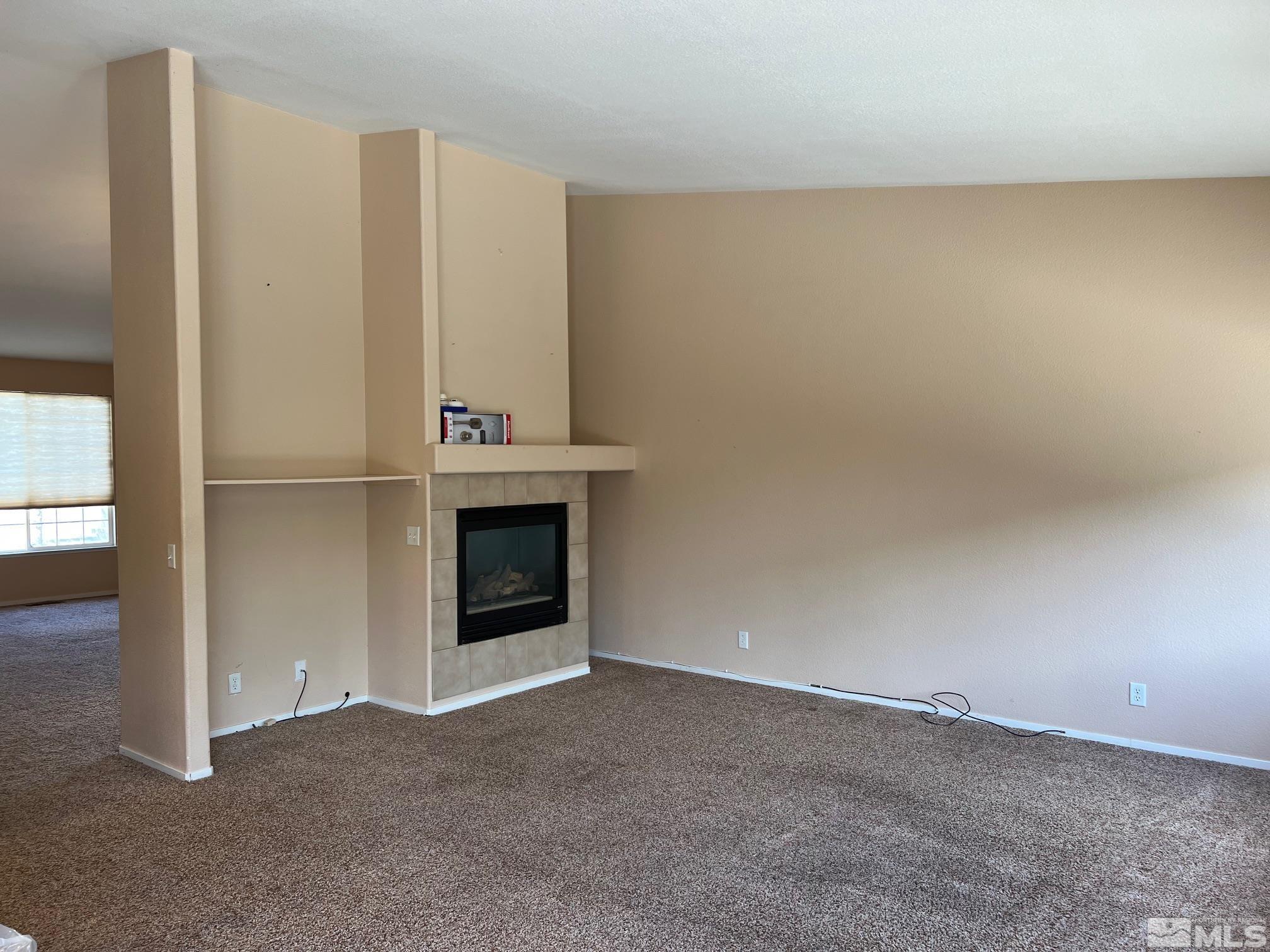 5458 Zeppelin Court Reno, NV 89523 - Photo 10 of 36 an empty room with a fireplace