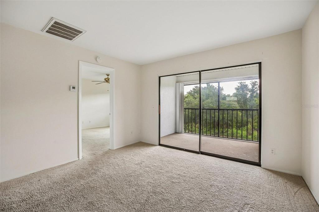 26485 Rampart Boulevard, Unit A27 Punta Gorda, FL 33983 - Photo 10 of 27 a view of empty room with sliding glass door