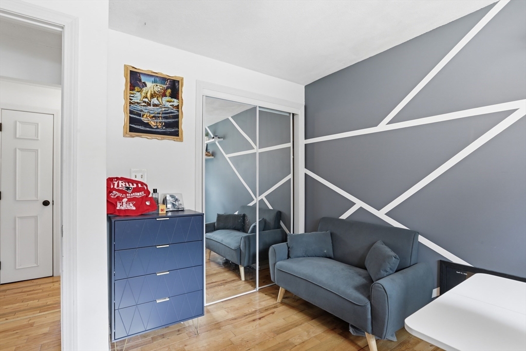 24 Clark Street Salem, MA 01970 - Photo 15 of 38 a living room with furniture and a ceiling fan